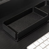 A black steel office accessories tray placed on a black-colored desk.
