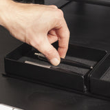 A black steel desk organizer set on a stand. The interior is finished with black felt.