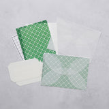 A letter-writing set with envelopes made of semi-transparent paper, decorative sheets for concealing the content of the letter in green, and address stickers.