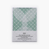 Packaging of a letter-writing set with envelopes made from semi-transparent paper and decorative sheets for concealing the content of the letter, in green.