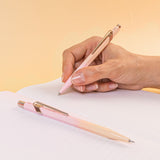 A pen and pencil on a lined notebook.