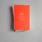 Pocket-sized softcover notebook with an illustration of a mushroom growing on the Moon.
