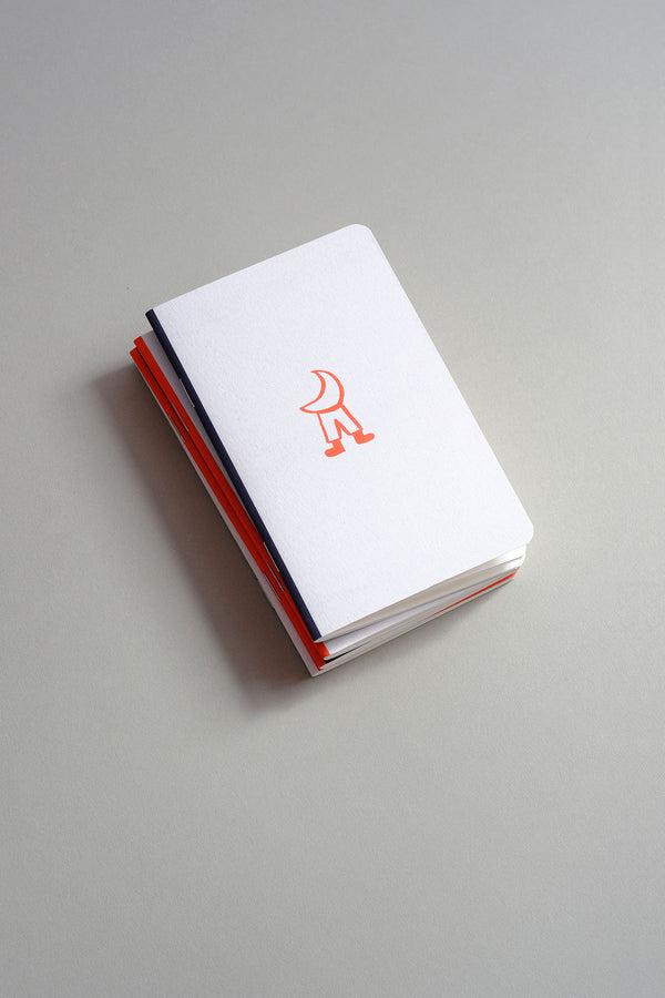A small light grey notebook with an orange illustration.