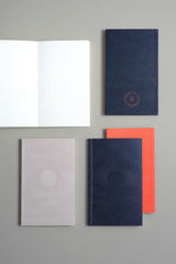 Plain inside notebooks from the Luna collection featuring a moon motif and an orange Papierniczeni brand logo on the back.