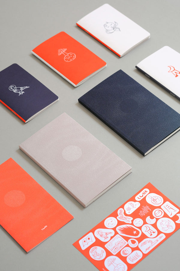 Notebooks and stickers with a moon motif from the Luna collection.