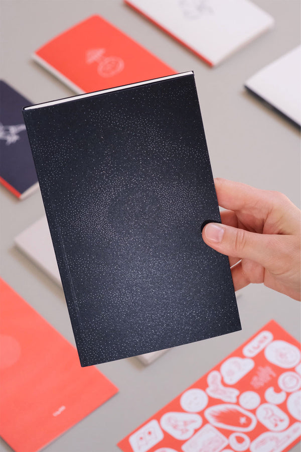 A navy softcover notebook with 112 plain pages inside.
