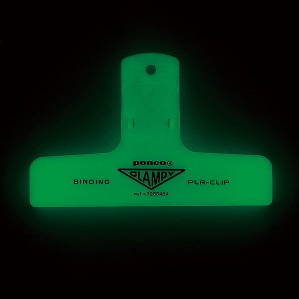 A plastic paper clip that glow in the dark.