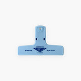 A light blue plastic paper clip with a logo featuring the Penco brand name.