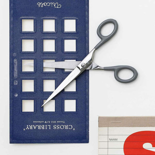 Steel scissors with grey handles and the Penco brand name engraved on them.