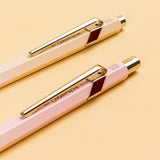 The clips securing the writing instruments from the Horizon collection, with the Caran d'Ache logo positioned on the barrel below them.