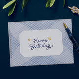 A semi-transparent envelope sealed with a sticker that says “Happy Birthday".