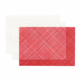A semi-transparent envelope with a sheet of decorative paper in red.