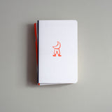 Pocket-sized softcover notebook with a moon motif.