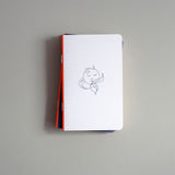 Pocket-sized softcover notebook with an illustration of a sleeping Moon.
