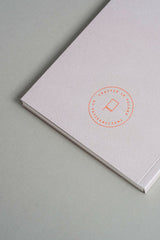Back cover of the beige Luna notebook with the orange Papierniczeni brand logo.