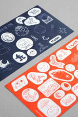 A set of moon-themed stickers in orange and navy colors.