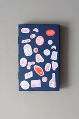 A navy paper box decorated with space-themed stickers.